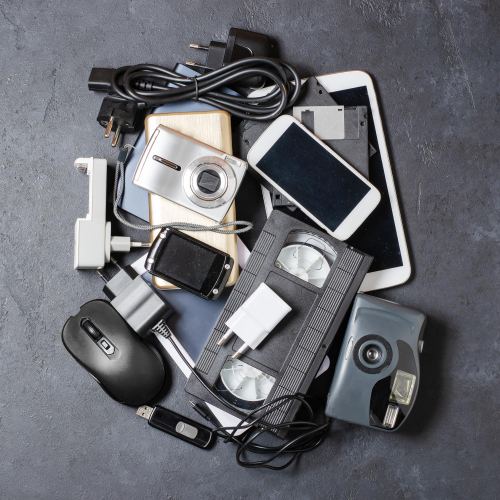 a pile of old and discarded electronic devices
